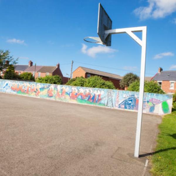 A concrete area with a basketball hoop